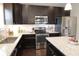 Modern kitchen featuring granite countertops, stainless steel appliances and dark cabinets at 11155 Funny Cide Dr, Noblesville, IN 46060