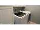 Laundry room with white cabinets and modern, front-load washer and dryer at 11155 Funny Cide Dr, Noblesville, IN 46060