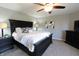 Bedroom with a large dark wood bed frame, neutral-colored walls, and a ceiling fan for added comfort at 11155 Funny Cide Dr, Noblesville, IN 46060