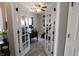 Office space featuring french doors, a modern desk, a comfortable chair, and exercise equipment for a balanced lifestyle at 11155 Funny Cide Dr, Noblesville, IN 46060