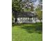 The back of this one-story home shows its cozy backyard and simplistic design at 114 S Catherwood Ave, Indianapolis, IN 46219