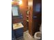 Compact bathroom design with blue vanity, shelf storage, and a matching blue towel rack at 114 S Catherwood Ave, Indianapolis, IN 46219