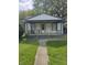 Charming single-story home with a cozy front porch and well-maintained lawn at 114 S Catherwood Ave, Indianapolis, IN 46219