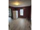 This kitchen includes updated flooring and a white refrigerator illuminated by natural light from a window at 114 S Catherwood Ave, Indianapolis, IN 46219