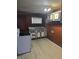 This kitchen features a vintage range and sink with updated flooring and contrasting cabinetry at 114 S Catherwood Ave, Indianapolis, IN 46219