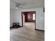 Open concept living room with updated flooring, and view to kitchen with white refrigerator at 114 S Catherwood Ave, Indianapolis, IN 46219