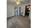 Open concept living room with updated flooring, and views to bedroom and bathroom at 114 S Catherwood Ave, Indianapolis, IN 46219