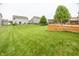 Backyard featuring a wooden deck and lush green lawn, great for outdoor activities at 11818 Bellhaven Dr, Fishers, IN 46038