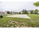 Community basketball court surrounded by green grass and houses in background at 11818 Bellhaven Dr, Fishers, IN 46038