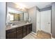 Bathroom featuring a double vanity, framed mirror, granite countertop, and neutral-colored walls and cabinetry at 11818 Bellhaven Dr, Fishers, IN 46038