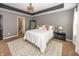 A neutral-toned bedroom features a tray ceiling, plush carpet, and an ensuite bathroom with a glass shower at 11818 Bellhaven Dr, Fishers, IN 46038