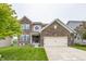 Charming two-story brick home with a well-maintained lawn and attached two car garage at 11818 Bellhaven Dr, Fishers, IN 46038