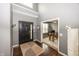 Bright foyer featuring wood floors, a black front door, and an adjacent office space at 11818 Bellhaven Dr, Fishers, IN 46038