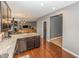Open kitchen with a view to the living room, featuring granite countertops and dark wooden cabinets at 11818 Bellhaven Dr, Fishers, IN 46038