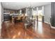 Open-concept kitchen and dining area with stainless steel appliances, dark wood cabinets, and hardwood floors at 11818 Bellhaven Dr, Fishers, IN 46038
