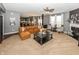 Open-concept living room with a large leather sofa, neutral walls, fireplace, and view into the kitchen at 11818 Bellhaven Dr, Fishers, IN 46038