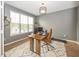 Home office with gray walls, a large window, modern desk, and contemporary decor at 11818 Bellhaven Dr, Fishers, IN 46038