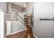Hallway with hardwood floors, staircase with white railings, and gray walls leading to the upper level at 11818 Bellhaven Dr, Fishers, IN 46038