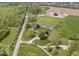 Expansive property featuring a large, well-maintained lawn, outbuildings and a charming home surrounded by mature trees at 1242 W Huntsville Rd, Pendleton, IN 46064