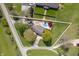 An aerial view showcases the house surrounded by a large yard, mature trees and an in-ground pool at 1242 W Huntsville Rd, Pendleton, IN 46064