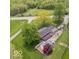 Aerial view showcasing a private pool and deck area complementing a house with a serene, tree-lined backdrop at 1242 W Huntsville Rd, Pendleton, IN 46064