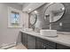 Modern bathroom featuring double sinks, custom cabinetry, and decorative wall mirrors at 1242 W Huntsville Rd, Pendleton, IN 46064