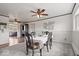 Bright dining room featuring neutral colors, wainscoting detail, and a ceiling fan with lighting at 1242 W Huntsville Rd, Pendleton, IN 46064