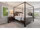 Spacious main bedroom featuring a four-poster bed, windows and neutral colors at 1242 W Huntsville Rd, Pendleton, IN 46064