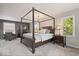 This main bedroom features a four-poster bed, windows and a sitting area at 1242 W Huntsville Rd, Pendleton, IN 46064