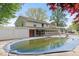 Back of house with a large in-ground pool, back patio area and well maintained yard at 1242 W Huntsville Rd, Pendleton, IN 46064