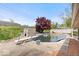 In ground pool with diving board, privacy fence, patio, and minimal landscaping at 1242 W Huntsville Rd, Pendleton, IN 46064