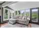 Bright sunroom with large windows, wood floors, and cozy seating for relaxation and enjoying natural light at 1242 W Huntsville Rd, Pendleton, IN 46064