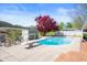 An in-ground swimming pool in the backyard featuring a diving board and adjacent lounging area at 1242 W Huntsville Rd, Pendleton, IN 46064