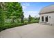 Landscaped backyard featuring a concrete patio, manicured lawn, and a view of the lake at 12739 Kiawah Dr, Carmel, IN 46033