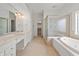 Serene bathroom featuring a soaking tub, glass-enclosed shower, and dual vanity sinks at 12739 Kiawah Dr, Carmel, IN 46033