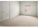Neutral bedroom featuring beige carpet, a window with blinds and a double door closet at 12739 Kiawah Dr, Carmel, IN 46033