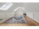 Bright bonus room with hardwood floors, ceiling fan, skylights, and a decorative rug at 12739 Kiawah Dr, Carmel, IN 46033