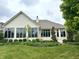 Home exterior featuring a well-manicured lawn, lush landscaping, and multiple windows at 12739 Kiawah Dr, Carmel, IN 46033
