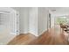 Hallway with hardwood floors and white trim leads to living spaces at 12739 Kiawah Dr, Carmel, IN 46033