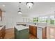Bright kitchen boasts wood floors, a center island, and scenic views from the adjacent dining area at 12739 Kiawah Dr, Carmel, IN 46033