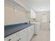 Bright laundry room features a blue countertop, white cabinetry, washer and dryer at 12739 Kiawah Dr, Carmel, IN 46033