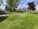 Lush backyard featuring a well-maintained lawn and mature trees, ideal for outdoor activities at 12974 Shandon Ln, Fishers, IN 46038