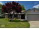 Charming single-Gathering home featuring a brick facade, attached garage, and mature tree in the front yard at 12974 Shandon Ln, Fishers, IN 46038
