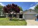 Attractive single-Gathering home showcasing a brick and siding exterior, a well-manicured lawn, and attached garage at 12974 Shandon Ln, Fishers, IN 46038