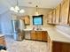 Functional kitchen with stainless steel appliances, tile flooring, and light oak cabinetry at 12974 Shandon Ln, Fishers, IN 46038