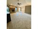 Spacious living room featuring a brick fireplace, neutral carpet, and a ceiling fan for comfortable living at 12974 Shandon Ln, Fishers, IN 46038