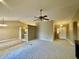Open living area with neutral carpet leading to the front door and kitchen area at 12974 Shandon Ln, Fishers, IN 46038