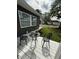 White back porch with a table and chairs. Overlooking a yard at 1327 Union St, Columbus, IN 47201