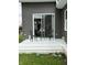 White back porch with a glass sliding door and a table with chairs at 1327 Union St, Columbus, IN 47201