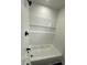 Bright bathroom featuring a tub with white subway tile and a convenient built-in shelf at 1327 Union St, Columbus, IN 47201